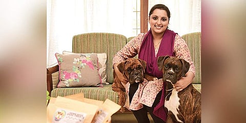 Jayalakshmi with her pet dogs. (Photo | Albin Mathew, EPS)