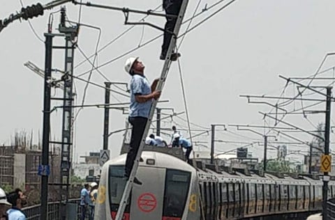 Maintenance teams of DMRC technicians working to restore Metro train services after technical glitch on Yellow line. (Photo | Twitter/DMRC)