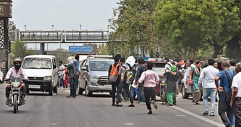 Commuters make a beeline for private taxis and buses outside the Chhatarpur station | pARVEEN NEGI