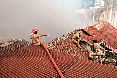 Firefighters dousing the fire at the Chellam Umbrella Mart Nandakumar H V