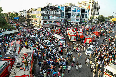 Firefighting trucks seen outside Taxshila Complex after a fire engulfed the third and fourth floor of the complex in Surat | PTI