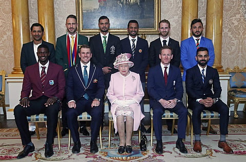 Britain's Queen Elizabeth II joins the captains of the teams taking part in the ICC Cricket World Cup for a photograph in the 1844 Room at Buckingham Palace, before a Royal Garden Party in London. (Photo | AP)