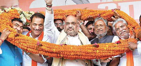 BJP President Amit Shah with Rajiv Pratap Rudy (left) and Sushil Modi (right) at a rally in Bihar’s Chapra district | PTI file