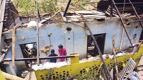 Children of a family retrieving essential items from the debris of their house after cyclone Fani in a village of Puri | biswanath swain