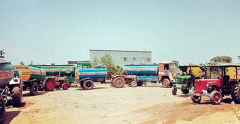 Lorries and tractors with water containers lining up at a make-shift filling station near Paduvanchery Main Road | Express