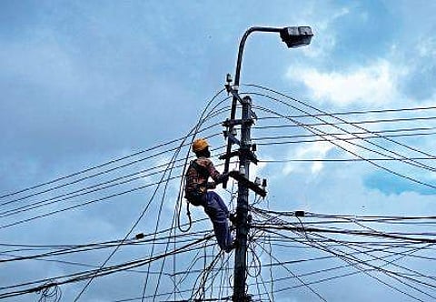 A KSEB worker engaged in work at Rajaji Nagar in the cityB P Deepu