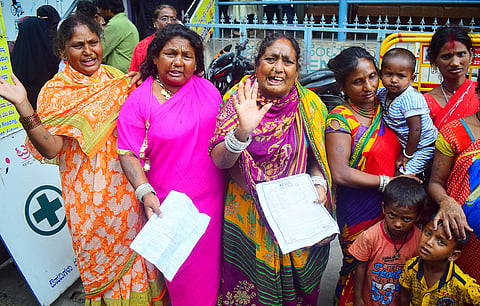 Members of a nomadic tribe from Odisha out side of IMA Jewels on Friday. They said they invested 70 lakh after selling thier land in Odisha. (Pandarinath B | EPS)