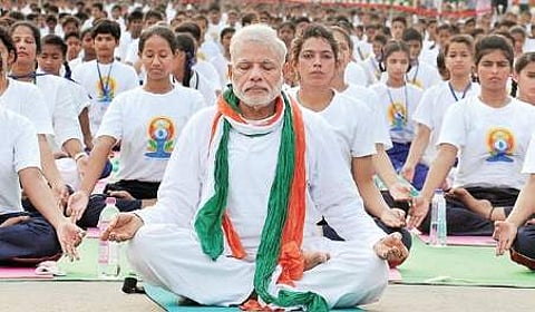 A file photo of PM Narendra Modi performing yoga at Rajpath in New Delhi.