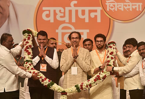 Shiv Sena Chief Uddhav Thackeray, Maharashtra Chief Minister Devendra Fadnavis (L ) and Yuva Sena chief Aditya Thyackeray being garlanded at the Foundation Day celebration of Shiv Sena Party in Mumbai Wednesday June 19, 2019. | PTI
