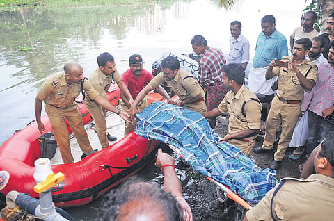 Navy and Fire and Rescue Service personnel taking out the body of Jennis who went missing in the backwater near Elamkulam on Sunday night after a day-long search on Monday | A Sanesh