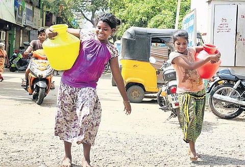 Darshini J (9) and Priya S (11) skip classes on alternate days to fetch water. (Photo | Debadatta Mallick, EPS)