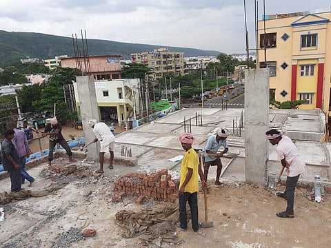 An illegal construction being removed by demolition squad in Visakhapatnam on Friday. (Photo | EPS)
