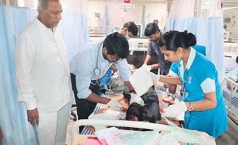 Ch Malla Reddy, Minister for Labour, rescues an accident victim at Balanagar on Monday. The victim was shifted to a hospital in city | Express