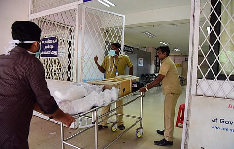 Medical staff at Kalamassery Government Medical College taking medical amenities and equipment to the isolation wards. (EPS | Albin Mathew, EPS)