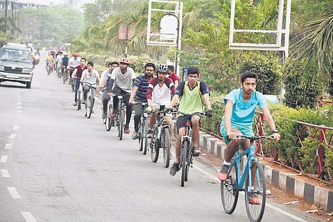 Cyclists ride along Necklace Road in Hyderabad | Express