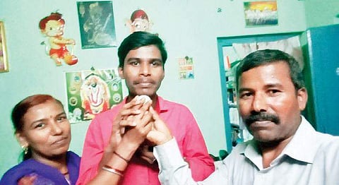 State topper Phaneendra D R celebrates his success with his parents