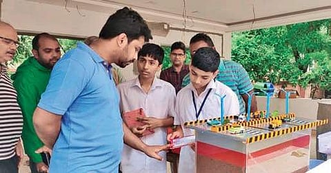 Students of TMRC municipal school demonstrate the model of RWH mechanism to VMC chief Prasanna Venkatesh in Vijayawada on Sunday | Express