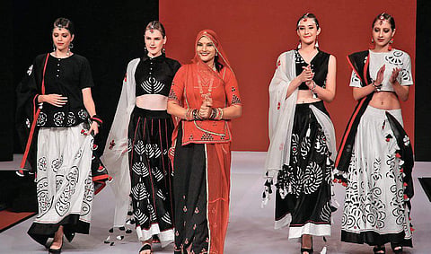 Winner of The Textiles Fairs India Fashion Design Awards 2019, Ruma Devi (in red) with models showcasing her collection
