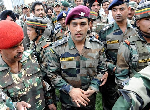 MS Dhoni (C), former Indian cricket team captain and honourary Lieutenant Colonel in the Indian Territorial Army, walks with military officers at the Army headquarters in Baramulla, north of Srinagar. (Photo | AFP)
