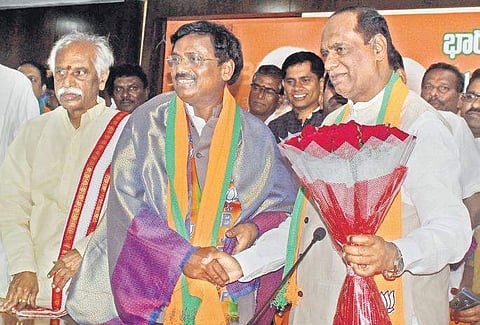 G Vivek, who recently joined the saffron party, with bjp State chief K Laxman in Hyderabad on Monday (Photo| EPS, Sathya keerthi0