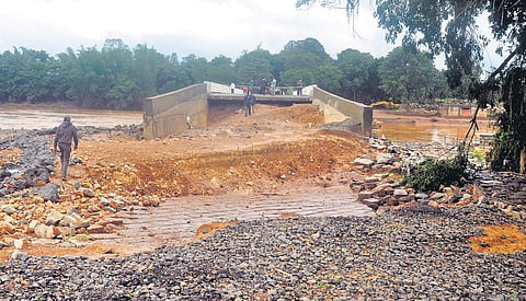 A portion of the bridge and road which were washed away during the floods at Khanapur in Belagavi district | Express
