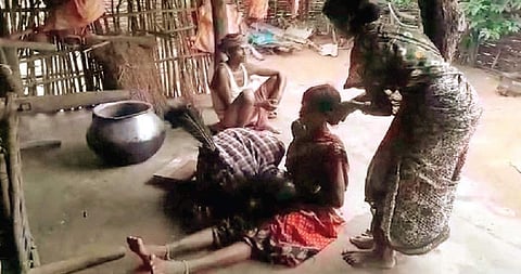 Sorcerer Kosa Beti biting Dule during her ‘treatment’ at Urmaguda village (File Photo |EPS)