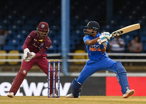 Shreyas Iyer (R) of India hits 4 as Shai Hope of West Indies look on during the 3rd ODI match between West Indies and India at Queens Park Oval, Port of Spain. (Photo | AP)