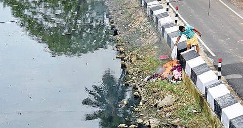 A resident burning garbage on the banks of Parvathy Puthanar at Karikkakom B P Deepu