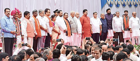 Governor Vajubhai Vala, Chief Minister B S Yediyurappa and the newly-inducted ministers pose for a photograph during the swearing-in ceremony at Raj Bhavan, in Bengaluru on Tuesday | Vinod Kumar T