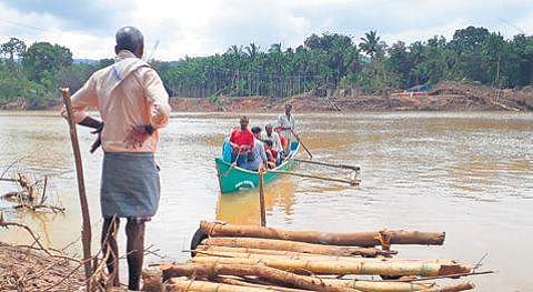 Villagers of Kalleshwar crossing Gangavali river in a boat to reach Ramanguli in Ankola taluk | Express