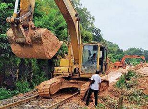 Earthmovers being used to clear debris off the railway track at Kulashekara on Friday | Express
