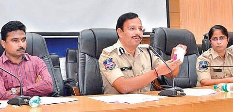 Cyberabad Police Commissioner Sajjanar displays products of QNet during a media conference in Hyderabad on Tuesday (Photo |EPS)