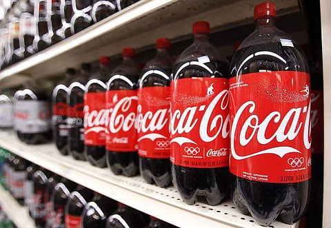 Bottles of Coca Cola are seen in a store display in New York. (Photo | Reuters)
