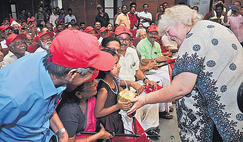 Dr Aleida Guevara giving a tender coconut to a child on Friday at a function marking the Cuban Solidarity Day | A Sanesh