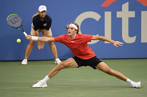 Stefanos Tsitsipas, of Greece, reaches to hit a forehand to Benoit Paire, of France, during the Washington Open. (Photo | AP)