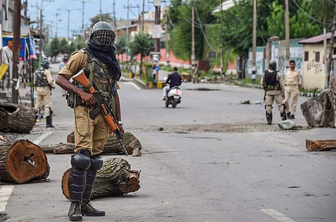 Security personnel stand guard at a check-point during curfew like restrictions following the abrogation of the provisions Article 370 in Jammu and Kashmir. (Photo | PTI)