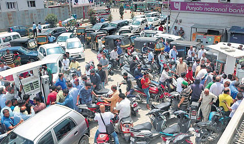 People wait to get petrol and diesel at a fuel pump in Srinagar on Saturday. There is a palpable tension among the locals after the Centre advised tourists to leave, cut short Amarnath Yatra and boosted security deployment. (Photo | Zahoor Punjabi)
