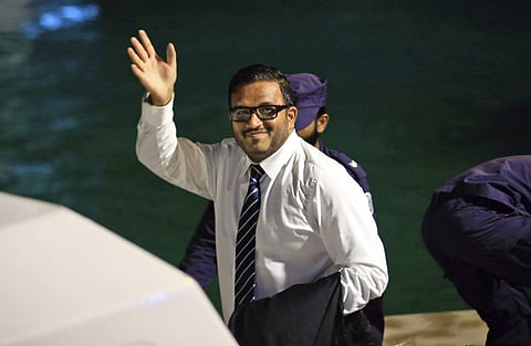 Former Maldives Vice President Ahmed Adeeb waves to the media before he boards a police speed boat in Maldives (File photo | AP)