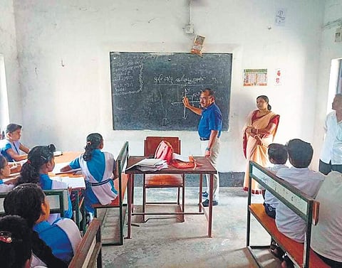 Jagatsinghpur Collector Sangram Keshari Mohapatra teaching Mathematics to students of Class IX at Manijanga High School on Wednesday (Photo| EPS)