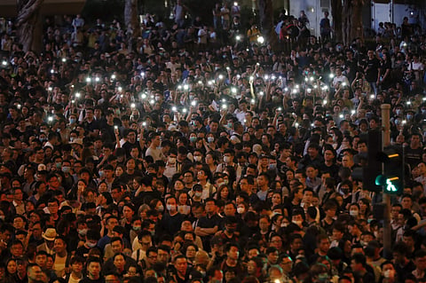 Protesters hold up the lights on their phones as they gather at a demonstration by civil servants in Hong Kong . (File Photo | AP)