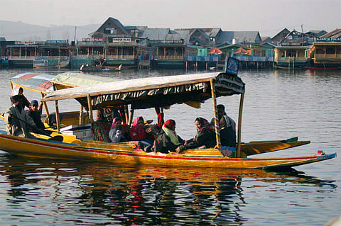 File photo of tourists enjoying on a Shikara in Dal lake in Srinagar. (File Photo | PTI)