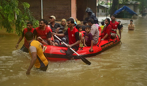 Fire and Rescue Service using boats to evacuate people stranded in the flood water in the heavy rain at Thengilakkadavu area in Kozhikode. (Photo | Manu R Mavelil, EPS)