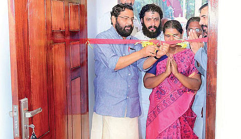 Devaswom Minister Kadakampally Surendran accompanies Ramani as she enters her new house built by the TDB at Vellarada on Tuesday | Express