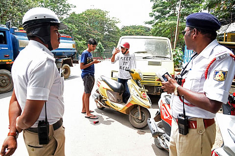 Traffic policemen check motorists on Wednesday. (Photo | Nagaraj Gadekal, EPS)