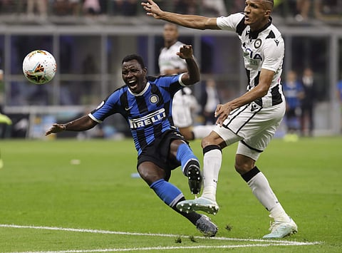 Inter Milan's Kwadwo Asamoah, left, is tackled by Udinese's Rodrigo Becao. (Photo | AP)