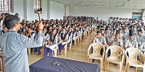 Principal R M Bhat broke two of the mobile phones with a hammer in front of the students and warned them not to bring phones to the campus.