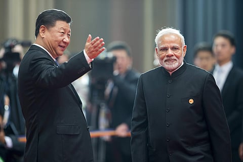 File photo of Chinese President Xi Jinping, left, welcoming Indian Prime Minister Narendra Modi for a meeting at the Shanghai Cooperation Organization (SCO) Summit in Qingdao in eastern China's Shandong Province Sunday, June 10, 2018.