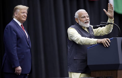 President Donald Trump listens as India Prime Minister Narendra Modi speaks during the 'Howdy Modi' event. (Photo | AP)