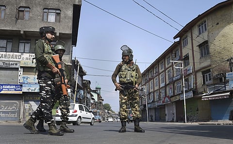 Security personnel stand guard during restrictions and shutdown in Srinagar on 26/09/2019. (Photo | PTI)