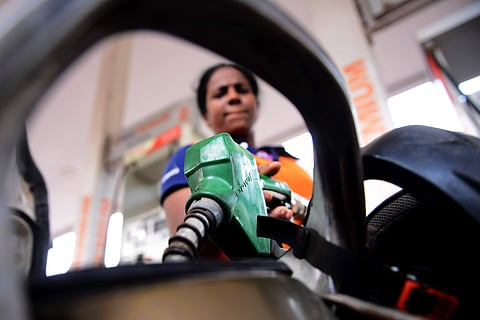 An employee at a petrol bunk fills fuel in a vehicle. (Photo | Debadatta Mallick, EPS)